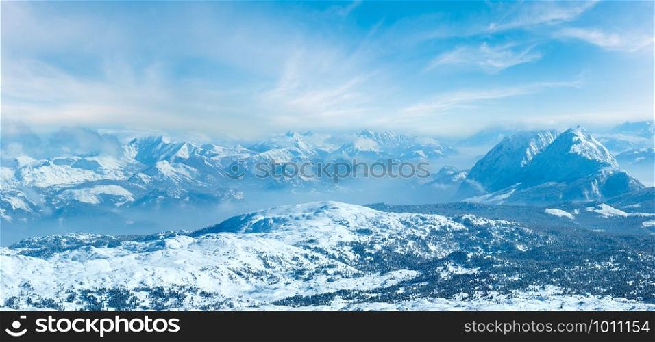 Winter hazy morning view from Dachstein mountain massif top (Austria). Panorama.