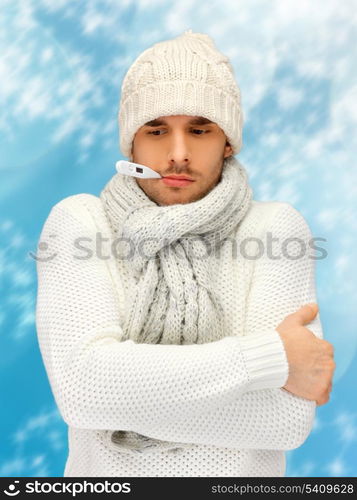 winter, health, medicine concept - sick man with thermometer in his mouth