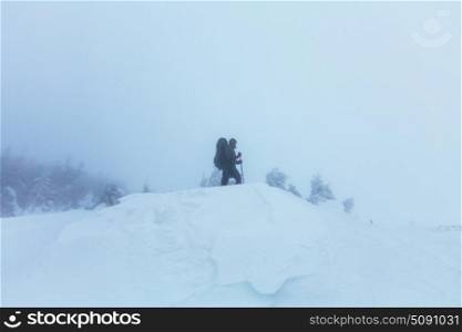 Winter hike. Hikers in the winter mountains