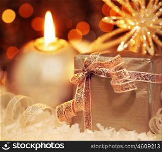Winter holiday background with silver present gift box, candle ornament &amp; Christmas snow decoration