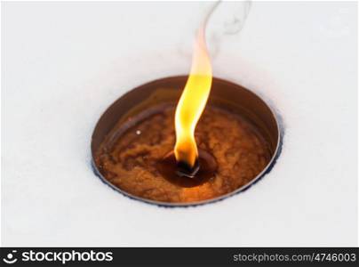 winter holidays and christmas concept - outdoor candle burning on snow. christmas outdoor candle burning on snow in winter