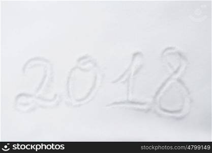 winter holidays and new year concept - calendar number 2018 or date on snow surface. new year 2018 number or date on snow surface