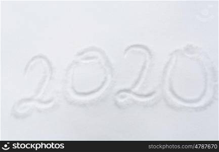 winter holidays and new year concept - calendar number 2020 or date on snow surface. new year 2020 number or date on snow surface