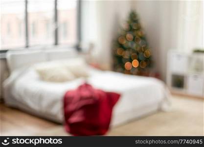 winter holidays, backgrounds and interior concept - blur image of bed in bedroom at cozy home on christmas. blurred bed in bedroom at cozy home on christmas