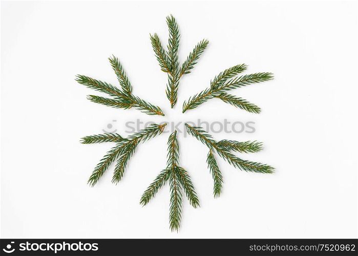 winter holidays, christmas and decorations concept - snowflake shape made of fir branches on white background. christmas snowflake shape made of fir branches