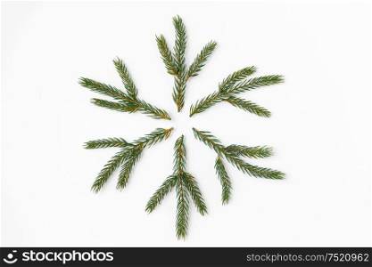 winter holidays, christmas and decorations concept - snowflake shape made of fir branches on white background. christmas snowflake shape made of fir branches