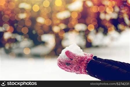 winter holidays, christmas and people concept - close up of woman holding snow outdoors. close up of woman holding snow outdoors