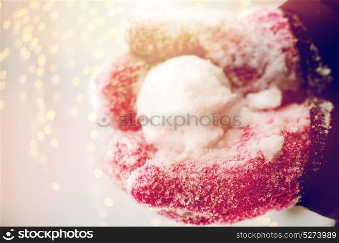 winter holidays, christmas and people concept - close up of woman holding snowball outdoors. close up of woman holding snowball outdoors