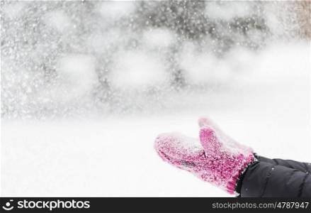 winter holidays, christmas and people concept - close up of woman throwing snow outdoors