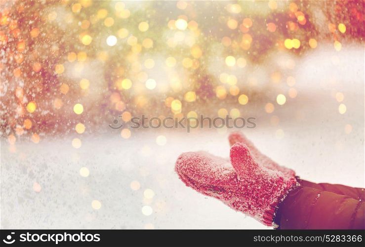 winter holidays, christmas and people concept - close up of woman throwing snow outdoors. close up of woman throwing snow outdoors