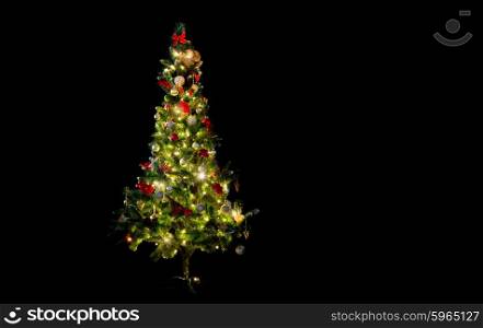 winter, holidays, decoration and illumination concept - beautiful decorated and illuminated christmas tree over black background
