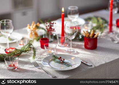 winter holidays, dinner party and celebration concept - close up of christmas table serving at home. christmas dinner party table serving at home