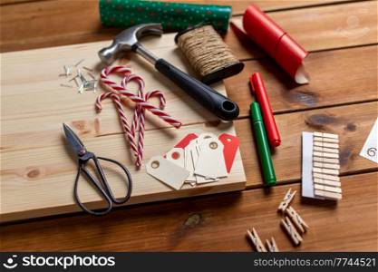 winter holidays, diy and hobby concept - close up of decorative stuff and work tools for christmas advent calendar making. decorative stuff for christmas advent calendar