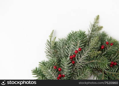 winter holidays, new year and decorations concept - wreath of fir branches with red berries on white background. christmas wreath of fir branches with red berries