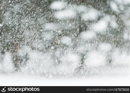winter holidays, precipitation, christmas, season and weather concept - snowing or snowfall