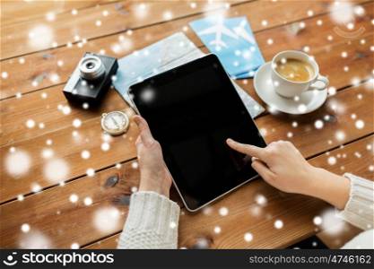 winter holidays, tourism, travel, technology and people concept - traveler hands with blank tablet pc computer and map over snow