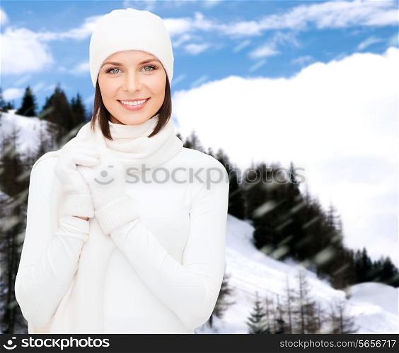 winter holidays, vacation, people and happiness concept - woman in hat, muffler and gloves