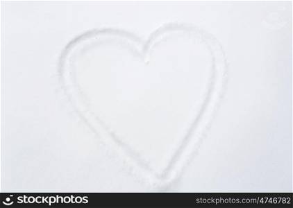 winter holidays, valentines day, love and christmas concept - heart shape silhouette or print on snow surface