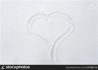 winter holidays, valentines day, love and christmas concept - heart shape silhouette or print on snow surface