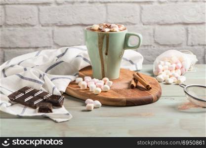 Winter hot drink. Hot chocolate or cocoa with marshmallow and spices on wooden background.