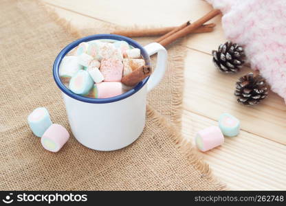 Winter hot drink. Hot chocolate or cocoa with pastel colour marshmallow on cozy table. - Image
