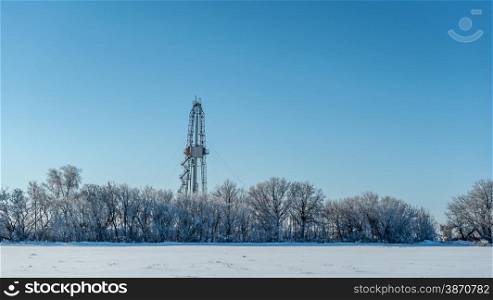 Winter landscape. Drilling rig for the snow-covered forest