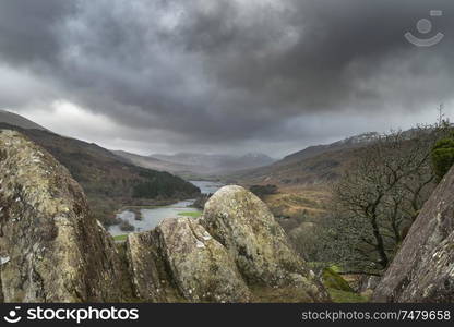 Winter landscape image of the view from Crimpiau and The Pinnacles towards Llynnau Mymbyr and snowcapped Snowdon in the distance