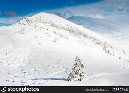Winter landscape in mountains with snow and blue hills