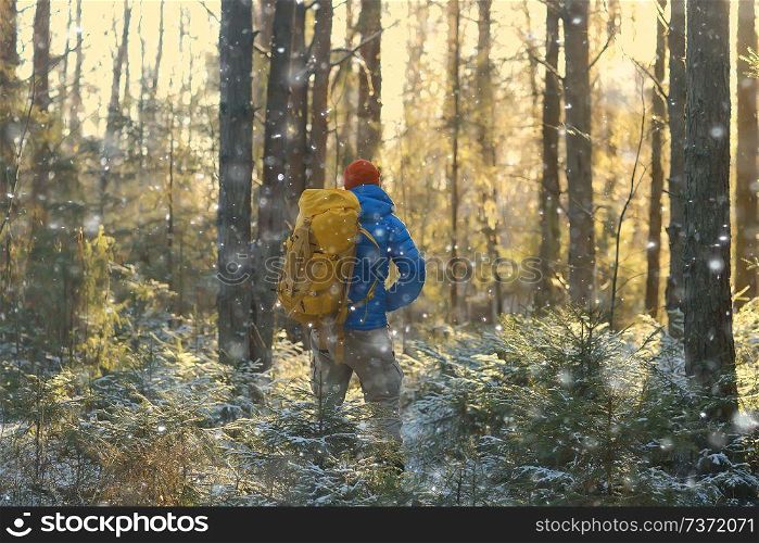 winter landscape man with a backpack / nature landscape a man on a hike with equipment in snowy weather in Canada