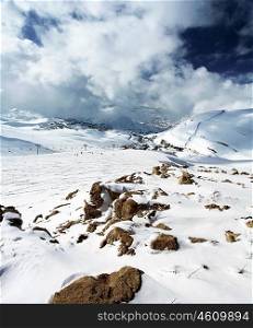 Winter landscape of high mountains with snow blizzard and fresh blue sky, beautiful nature image