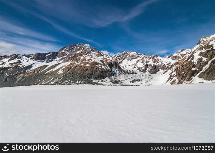 Winter landscape of snow mountain against blue sky. Beautiful nature scenery background.