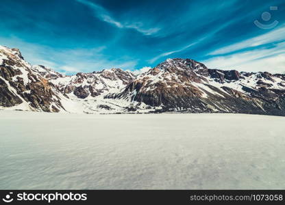 Winter landscape of snow mountain against blue sky. Beautiful nature scenery background.