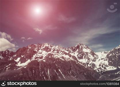 Winter landscape of snow mountain range and blue sky. Scenery background for mountain activities such as skiing, trekking, winter sport and mountain climbing.