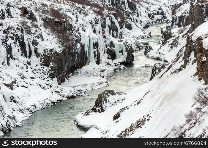 Winter landscape, river and cliff at northern Iceland