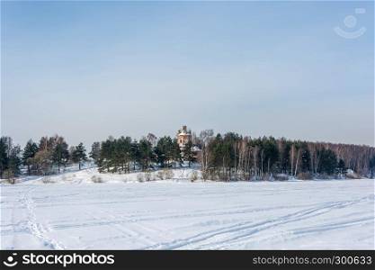 Winter landscape with old stone Church on the beautiful river Bank.