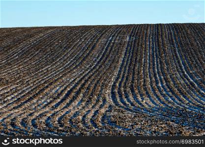 Winter landscape with plowed field