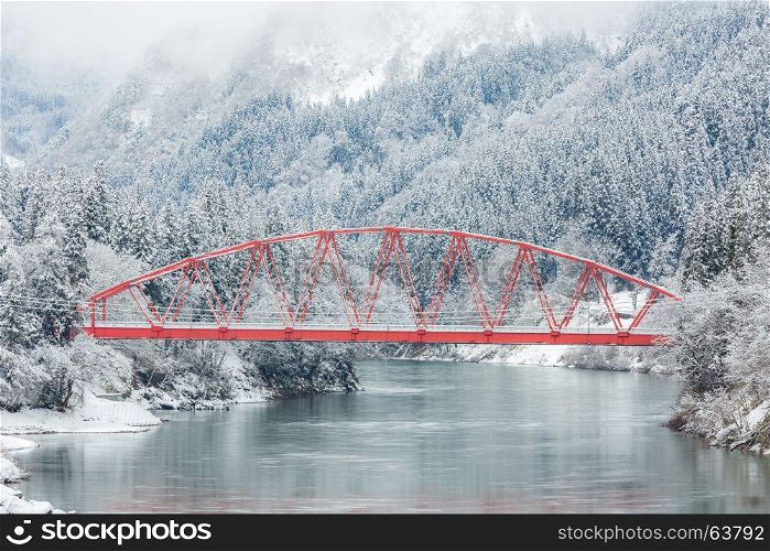 winter landscape with Red Bridge along Tadami River in Fukushima Japan