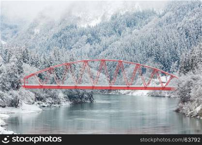 winter landscape with Red Bridge along Tadami River in Fukushima Japan