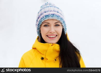 winter, leisure, clothing and people concept - happy young woman in winter clothes outdoors