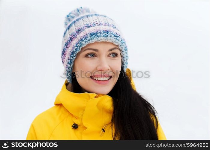 winter, leisure, clothing and people concept - happy young woman in winter clothes outdoors