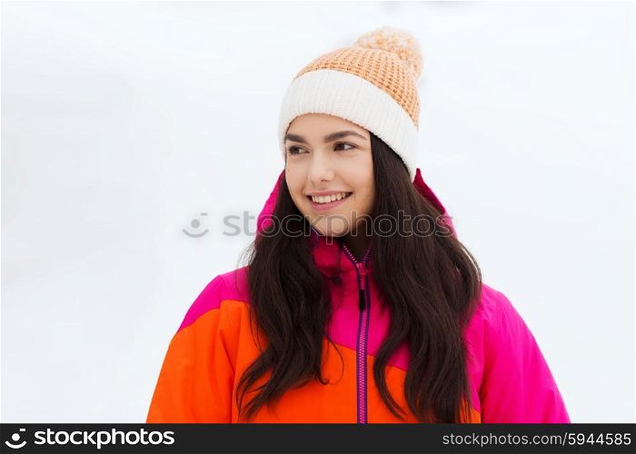 winter, leisure, clothing and people concept - happy young woman or teenage girl in winter clothes outdoors