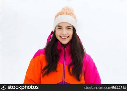 winter, leisure, clothing and people concept - happy young woman or teenage girl in winter clothes outdoors