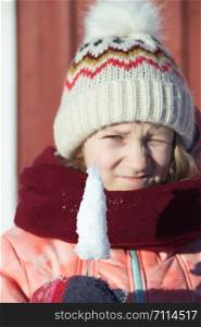 winter. little norwegian girl with an ice floe in hand. Norway