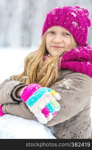 winter - little smiling girl outdoors at the snowfall time