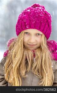 winter - little smiling girl outdoors at the snowfall time