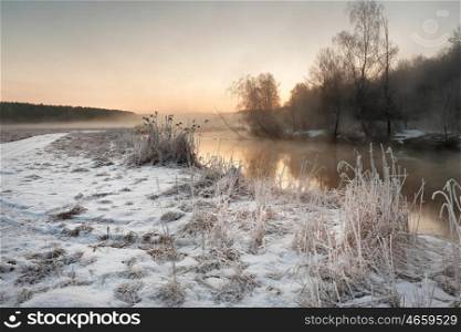 Winter misty dawn on the river. Rural foggy and frosty scene in Belarus