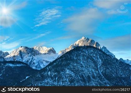 Winter morning sunshiny mountain landscape with forest on slope (Austria).