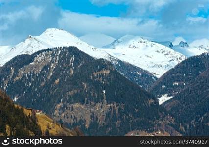 Winter mountain country landscape with forest on slope (Austria).