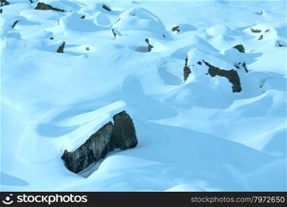 Winter mountain landscape with big stones on slope.