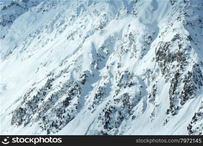 Winter mountain landscape with fir trees on slope, Austria.